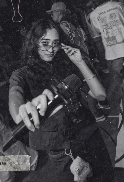 Jew Nuas holding a microphone at a dance event